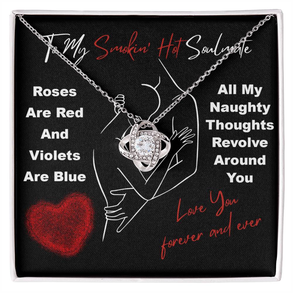 The Soulmate-Around You - Love Knot Necklace, featuring cubic zirconia crystals, rests elegantly in a black gift box with romantic text and a red heart design, making it the perfect unique gift.