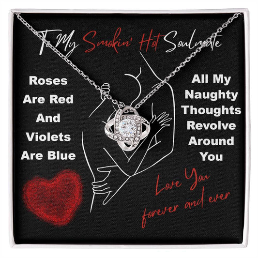 The Soulmate-Around You - Love Knot Necklace, featuring cubic zirconia crystals, rests elegantly in a black gift box with romantic text and a red heart design, making it the perfect unique gift.
