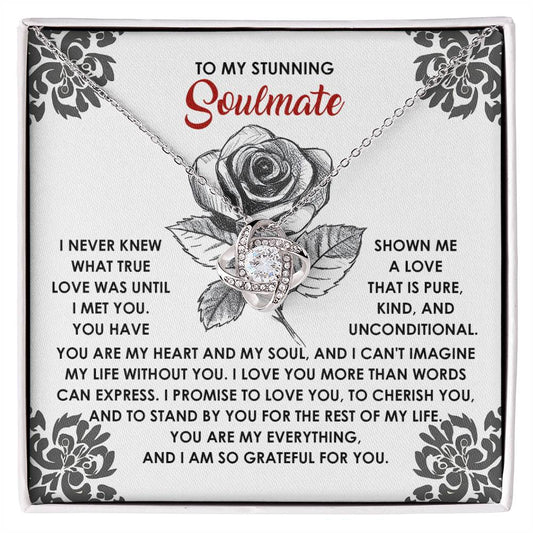 The Soulmate-Cherish You - Love Knot Necklace, featuring a rose design, is elegantly presented above a touching message about love on a decorative card. This personalized piece embodies the essence of timeless affection and grace.