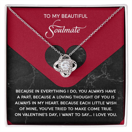 The Soulmate-Loving Thought - Love Knot Necklace features a heart-shaped pendant adorned with sparkling cubic zirconia crystals, elegantly packaged in a gift box labeled "To My Beautiful Soulmate" with a romantic message.