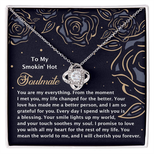 The Soulmate-My Soul 2 Love Knot Necklace features an intertwined circle pendant adorned with cubic zirconia crystals, presented in a floral-patterned box with golden rose illustrations and an affectionate message symbolizing an unbreakable bond.