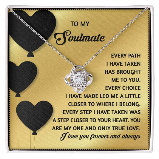 The Soulmate-A Step Closer - Love Knot Necklace features an infinity pendant with cubic zirconia crystals, presented on a card with black hearts and a romantic message titled "To My Soulmate," making it the perfect personalized gift to express your eternal love.