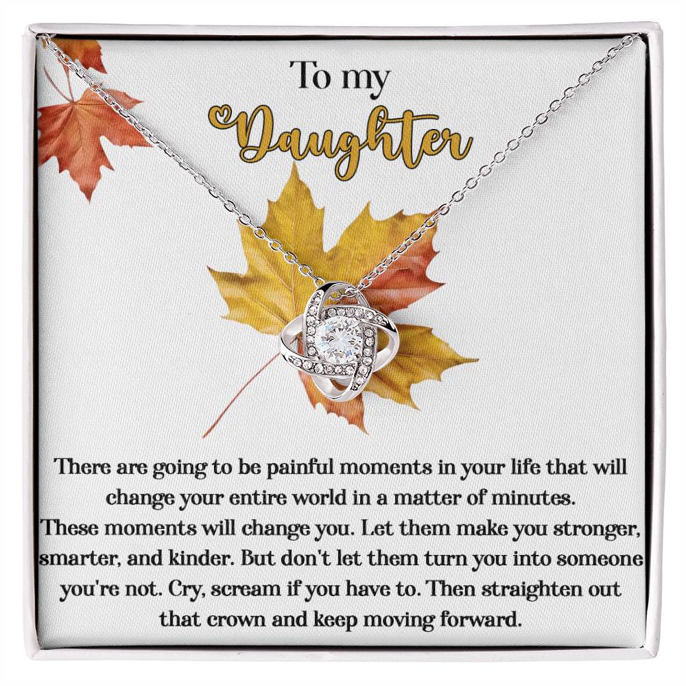 Present your daughter with the personalized "Daughter-Make You Stronger - Love Knot Necklace" featuring cubic zirconia crystals on a card decorated with fall leaves. The heartfelt message speaks of overcoming painful moments and growing stronger, serving as a poignant reminder to keep moving forward.