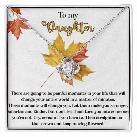 Present your daughter with the personalized "Daughter-Make You Stronger - Love Knot Necklace" featuring cubic zirconia crystals on a card decorated with fall leaves. The heartfelt message speaks of overcoming painful moments and growing stronger, serving as a poignant reminder to keep moving forward.