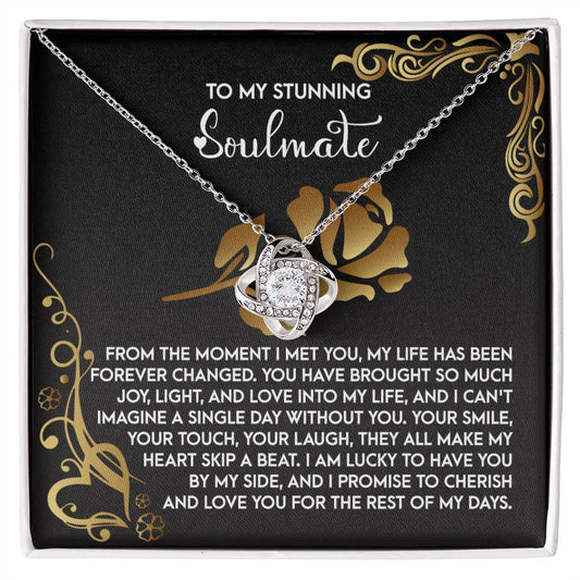 The Soulmate-I Met You 2 - Love Knot Necklace features a silver intertwined heart pendant with sparkling cubic zirconia, set in a black jewelry box. The lid shows a romantic message to a soulmate in white and gold, making it an ideal personalized gift.