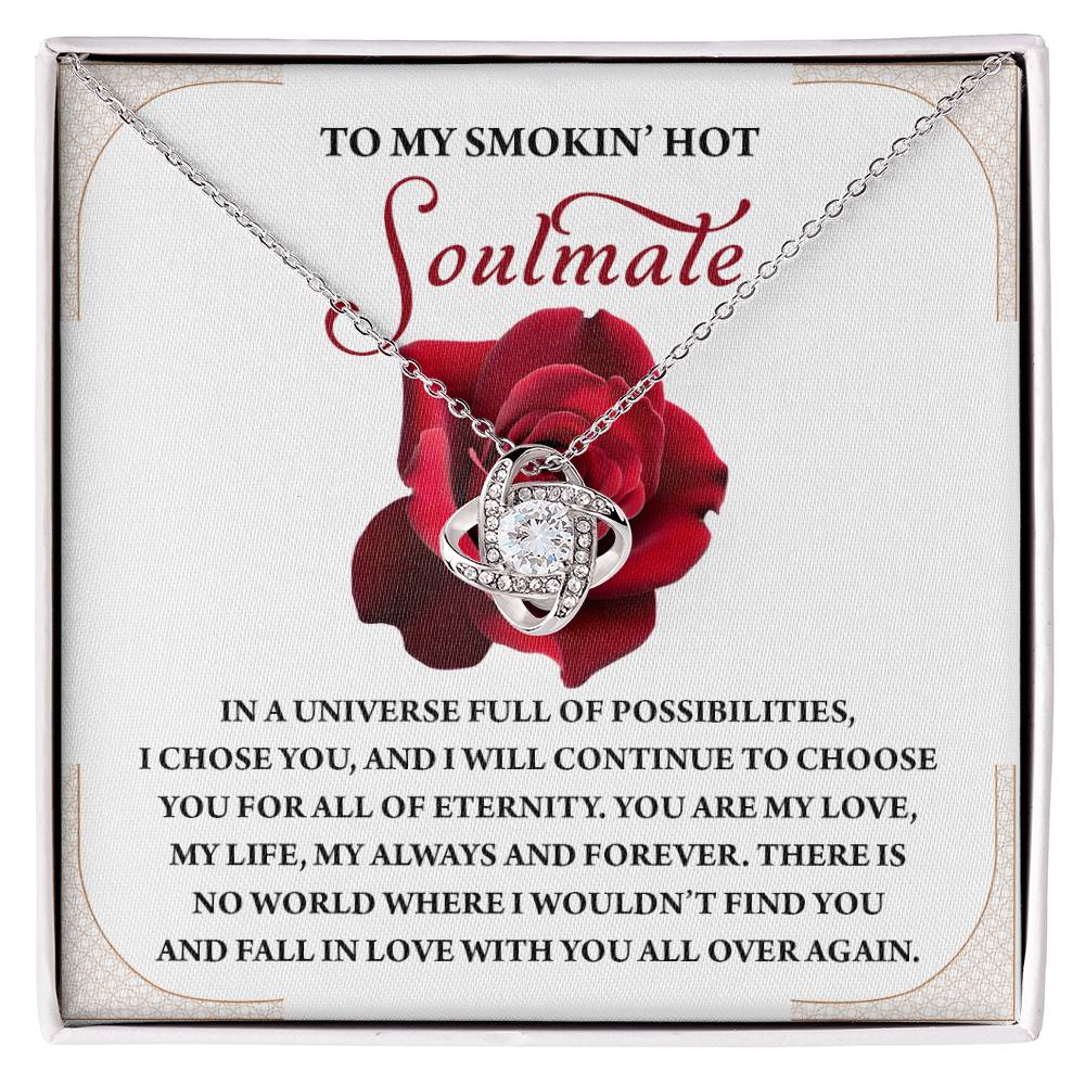 The Soulmate-Over Again Love Knot Necklace is showcased on a jewelry box with a red rose design and romantic message, enhanced by shimmering Cubic Zirconia Crystals.