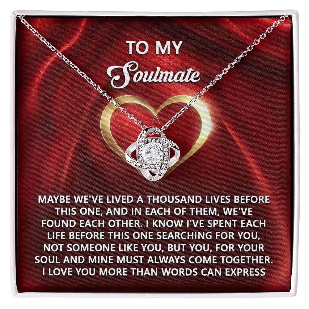 The Soulmate-Your Soul Love Knot Necklace, featuring an intertwined heart pendant with cubic zirconia, set against a passionate red backdrop, embodies the timeless bond of soulmates and is the perfect personalized gift for your true love.