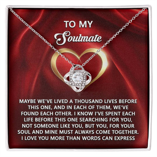 The Soulmate-Your Soul Love Knot Necklace, featuring an intertwined heart pendant with cubic zirconia, set against a passionate red backdrop, embodies the timeless bond of soulmates and is the perfect personalized gift for your true love.
