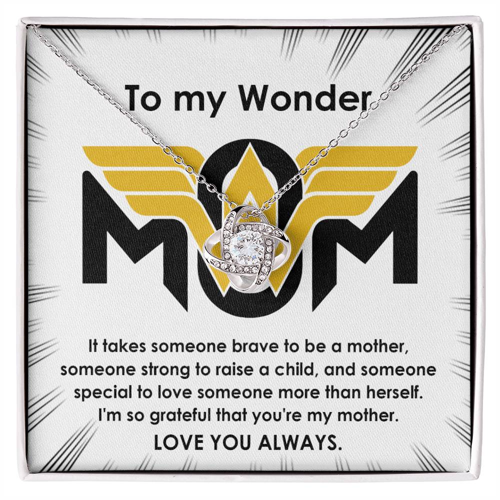 A To Mom, More Than Herself - Love Knot Necklace with a heart-shaped pendant and "mom" inside, presented in a box with a message expressing love and gratitude to a mother.