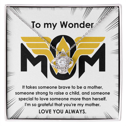 A To Mom, More Than Herself - Love Knot Necklace with a heart-shaped pendant and "mom" inside, presented in a box with a message expressing love and gratitude to a mother.