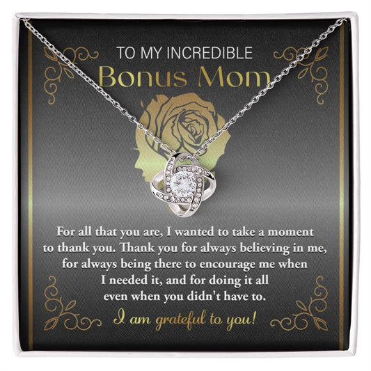 To Bonus Mom, To Encourage Me - Love Knot Necklace with a cubic zirconia Love Knot pendant inside a box featuring the message "to my incredible bonus mom" with a note of gratitude written below.