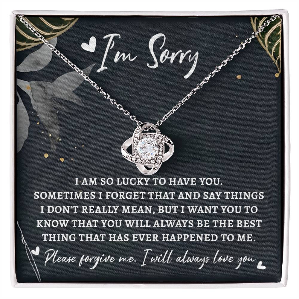 A Sorry-The Best Thing - Love Knot Necklace in a gift box featuring a note that reads "I'm Sorry," embellished with cubic zirconia crystals and accompanied by a heartfelt apology message expressing love and regret for misspoken words.