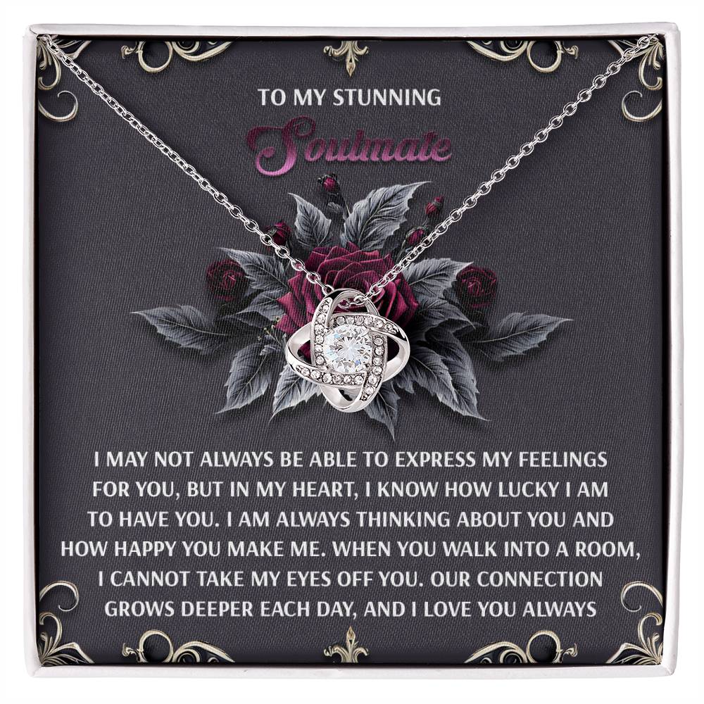 The Soulmate-Eyes Off You Love Knot Necklace features interlocking rings in white gold finish, a card adorned with roses and a message to your "stunning soulmate," and sparkling cubic zirconia accents - the perfect symbol of your unbreakable bond.
