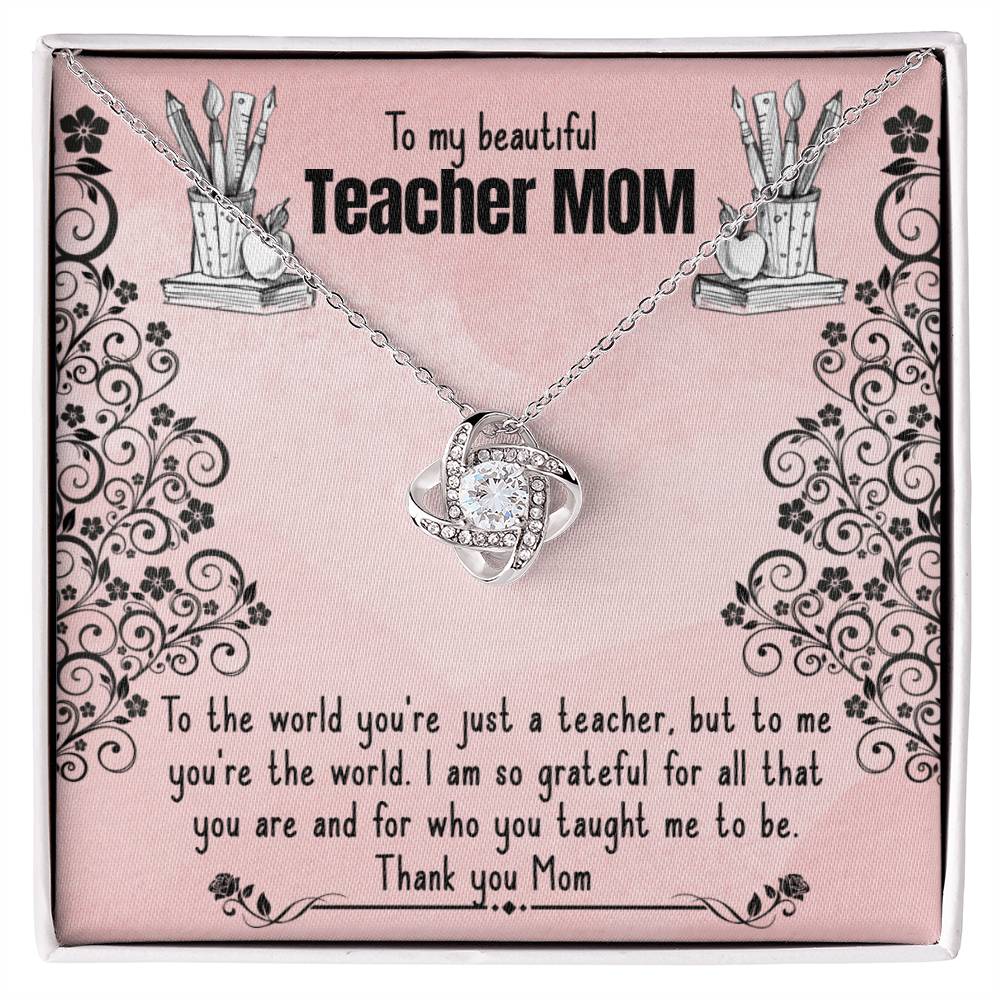 A To My Beautiful Teacher MOM, To The World You're Just A Teacher - Love Knot Necklace with a heart-shaped pendant is displayed on a pink background, featuring a personalized printed message dedicated to a 'teacher mom', expressing gratitude and admiration for her dual role as a mother and.