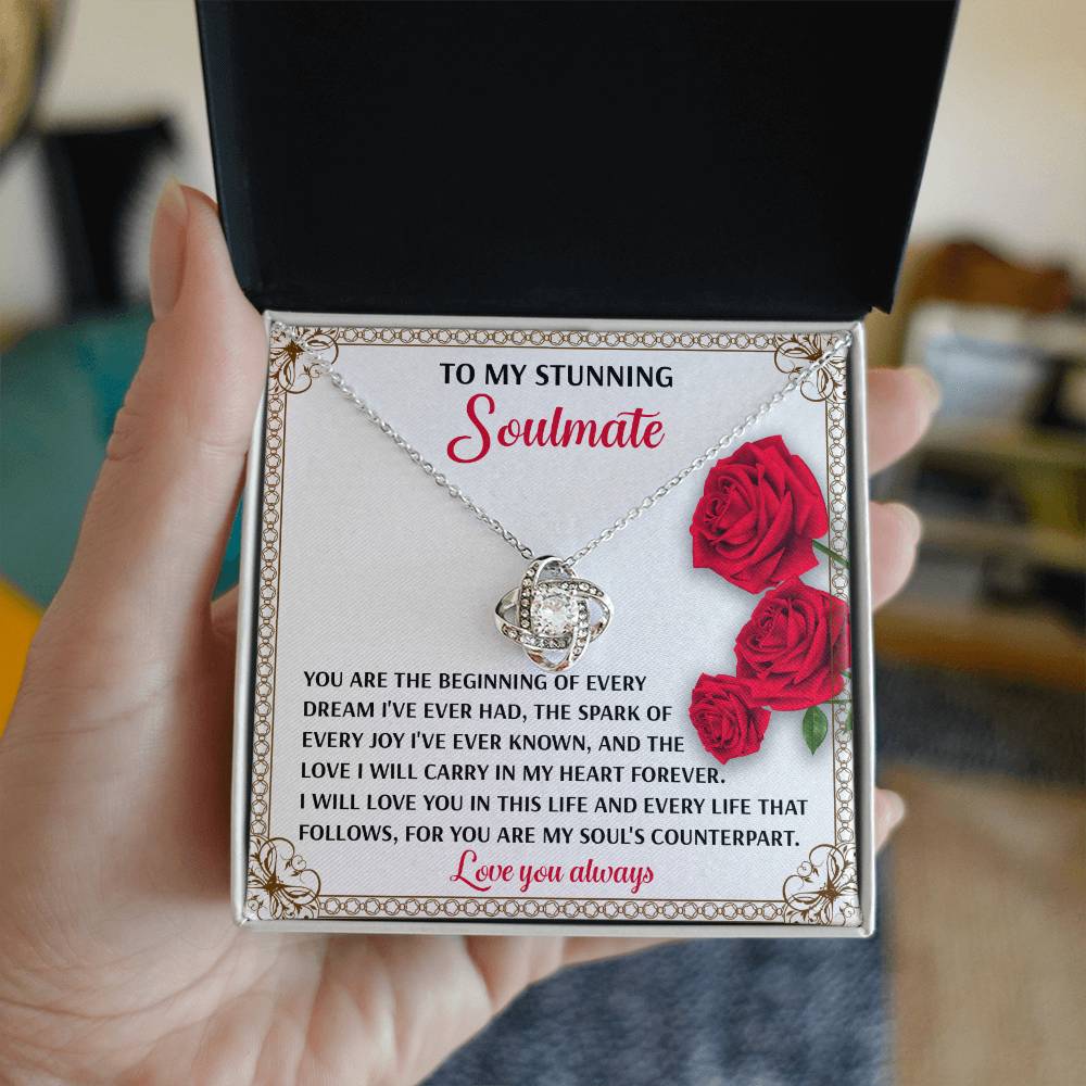 An open box reveals the beautiful Soulmate-Soul's Counterpart Love Knot Necklace with cubic zirconia crystals. The included message card, decorated with red roses, expresses deep love and admiration for a soulmate, making it an ideal personalized gift.