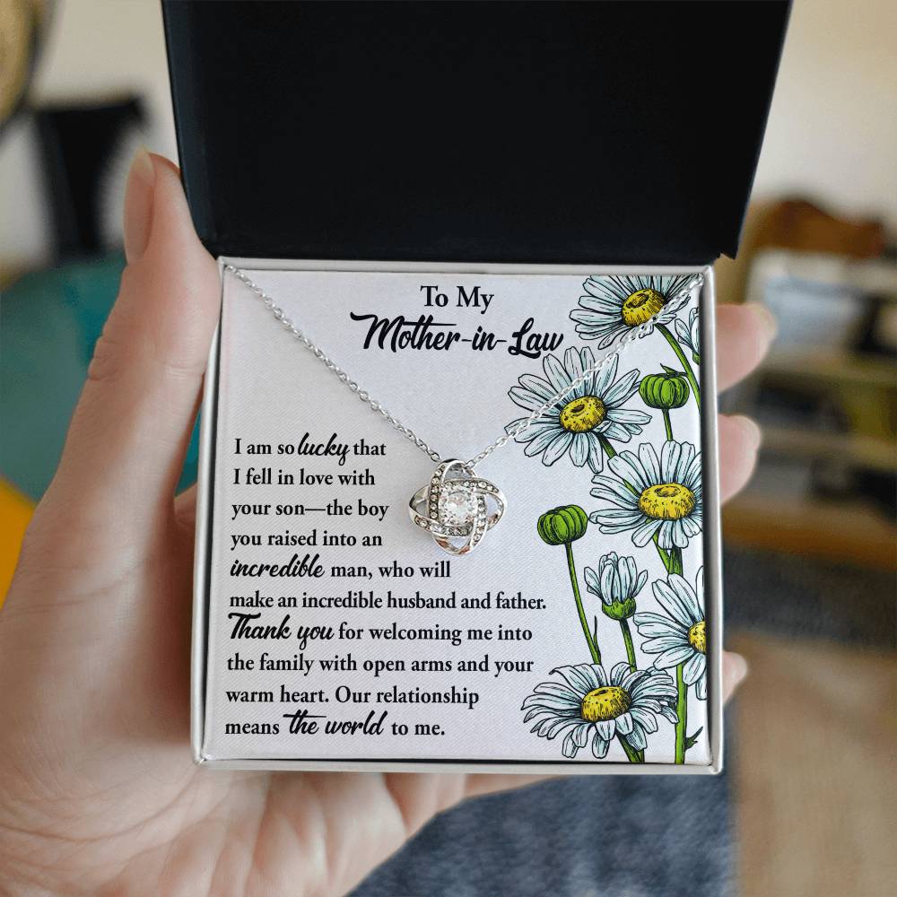 To Mother-In-Law, Warm Heart - Love Knot Necklace on a floral card with a heartfelt message to a mother-in-law, expressing gratitude and affection.