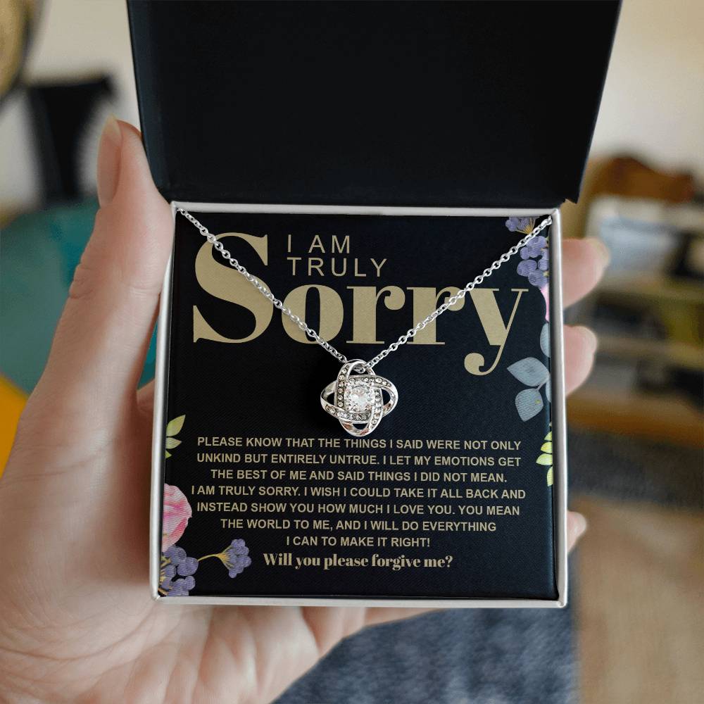 The Sorry-Best Of Me - Love Knot Necklace, featuring a heart-shaped cubic zirconia crystal pendant, is elegantly presented on a card with an apology message expressing deep regret and a sincere plea for forgiveness.