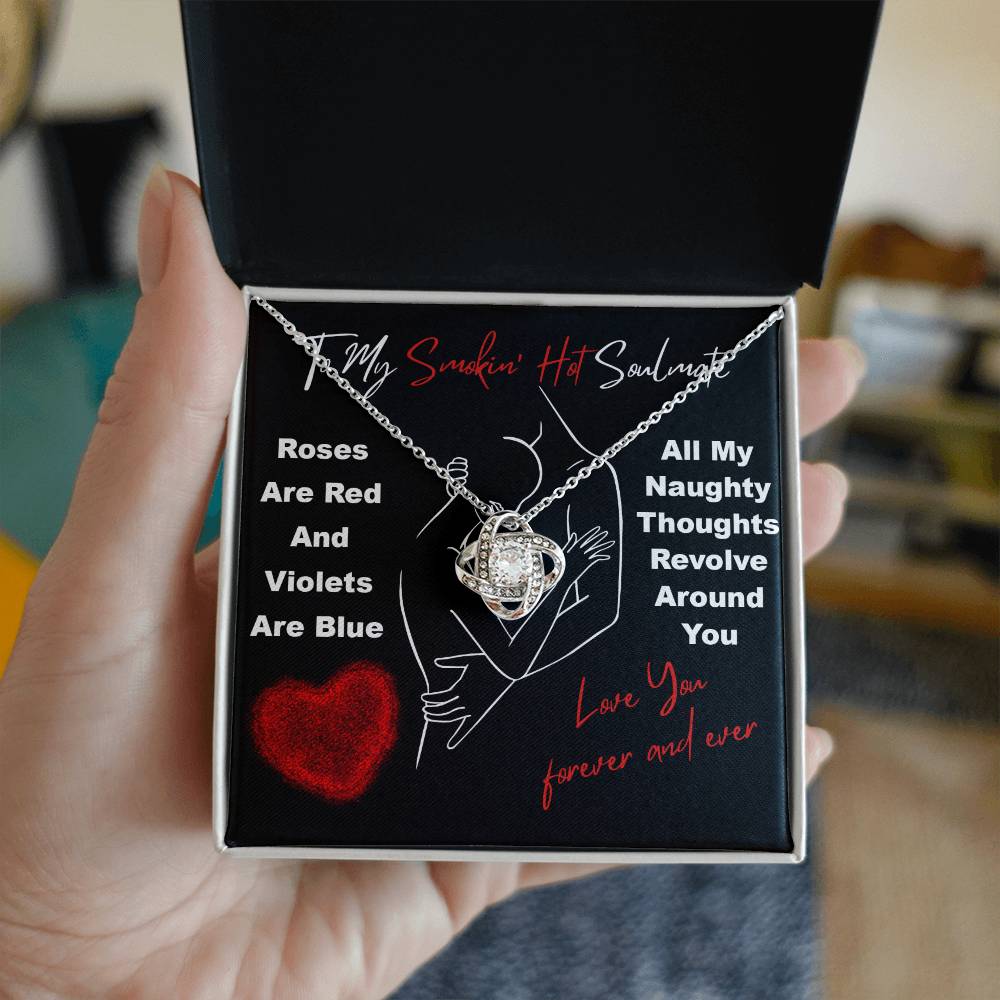 A hand holds a jewelry box with the Soulmate-Around You - Love Knot Necklace. The box is inscribed, "To My Smokin' Hot Soulmate," alongside a romantic poem. Sparkling cubic zirconia accents make this personalized gift truly unforgettable.