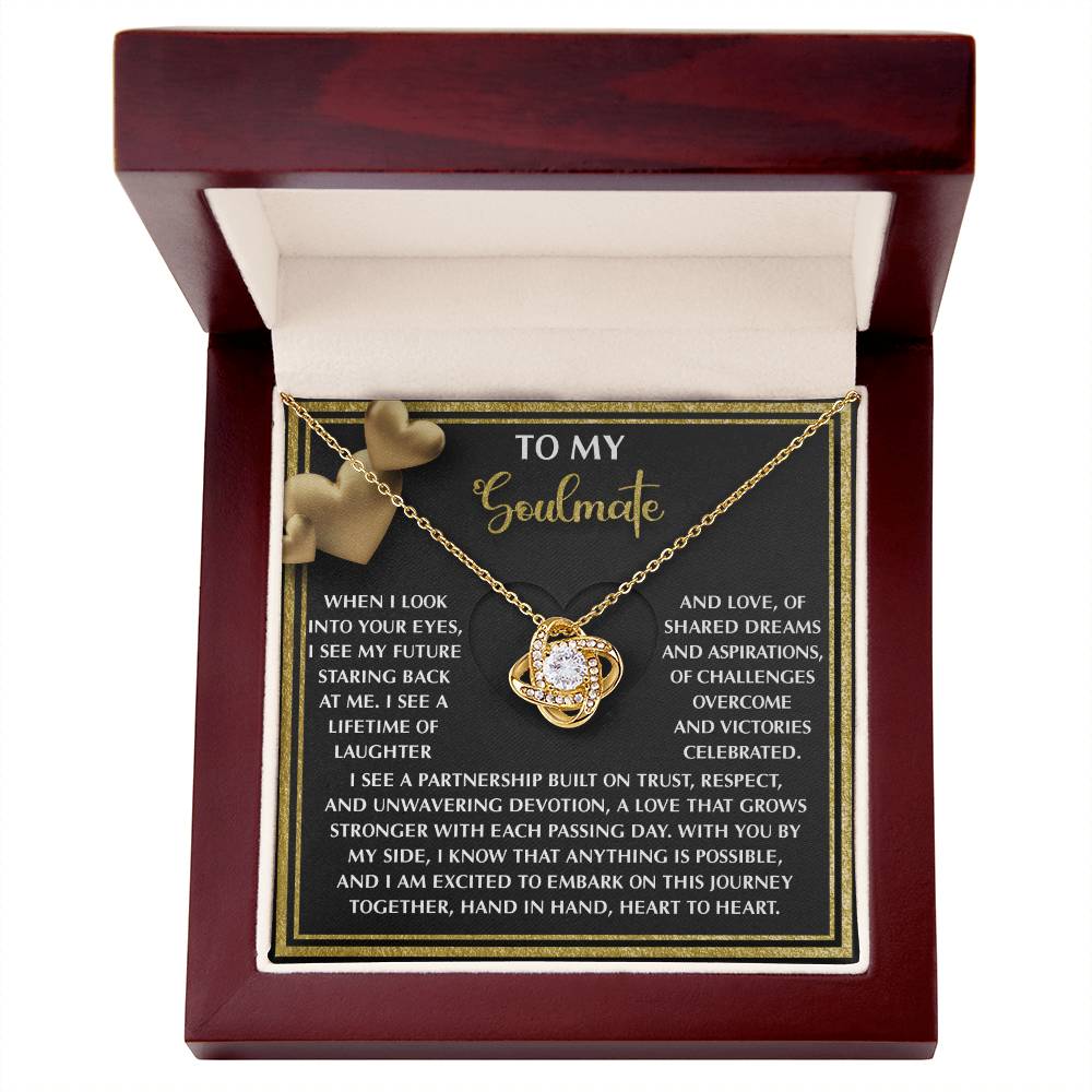 The Soulmate-Heart To Heart - Love Knot Necklace is a unique gift in a wooden box with a "To My Soulmate" message card and two heart shapes. Elegantly adorned with sparkling cubic zirconia crystals, it's perfect for expressing your deepest emotions.