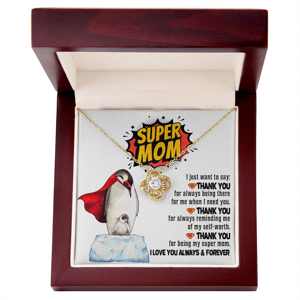 The "To Mom, Super Mom - Love Knot Necklace," beautifully presented in a red wooden box with a card bearing the message "Super Mom," features an image of penguins and a heartfelt expression of gratitude. This necklace, adorned with cubic zirconia, symbolizes the unbreakable bond you share and adds an extra touch of sparkle to this meaningful gift.