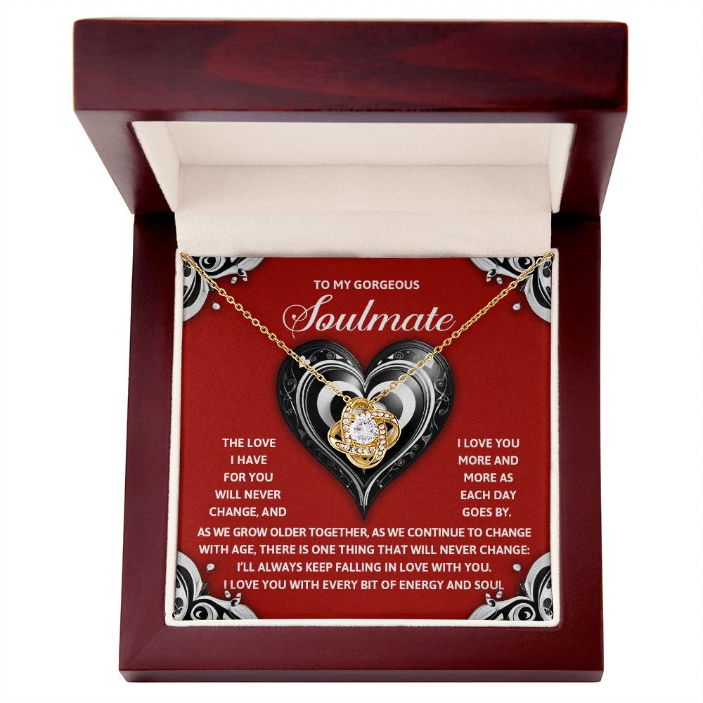 The Soulmate-Energy And Soul - Love Knot Necklace is beautifully crafted with a heart pendant, presented in a luxurious red velvet box. Available in white or yellow gold finish, it's adorned with sparkling cubic zirconia and comes with a heartfelt message about love and soulmates.