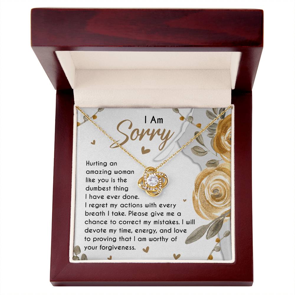 The Sorry-Amazing Woman - Love Knot Necklace features a heart-shaped pendant in a wooden box. The lid is decorated with an apology note adorned with floral decorations and cubic zirconia crystals, making it a classic gift.