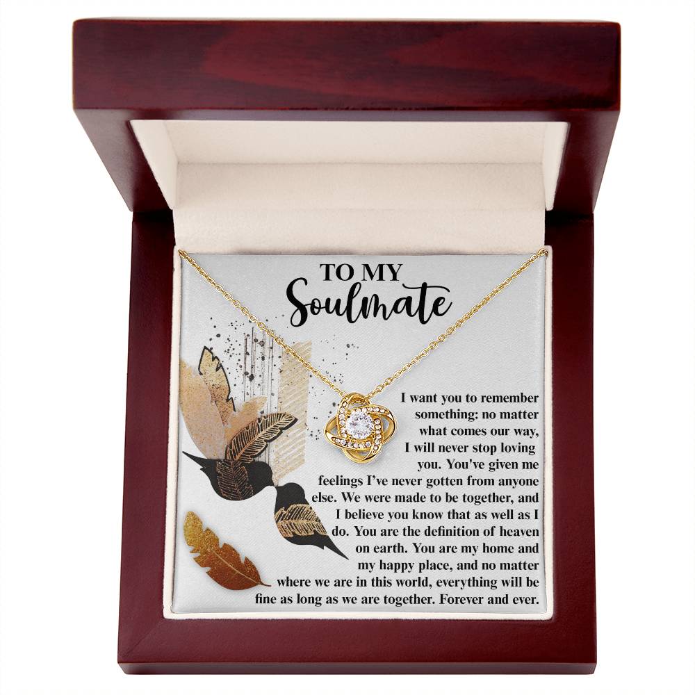 The **Soulmate-Given Me Feelings - Love Knot Necklace** features an intertwined circular pendant adorned with sparkling cubic zirconia crystals. It is elegantly displayed in an open wooden box, with the inner lid bearing a heartfelt message addressed "To My Soulmate," making it the perfect personalized gift.