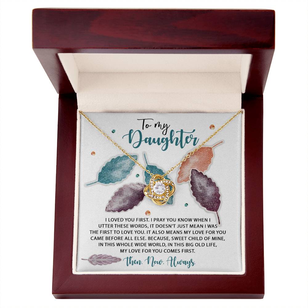 A personalized gift, this Daughter-Pray You Know - Love Knot Necklace jewelry box holds a beautiful necklace adorned with cubic zirconia crystals and a heartfelt message for a daughter. The message is elegantly set against a decorative background featuring colorful leaves.
