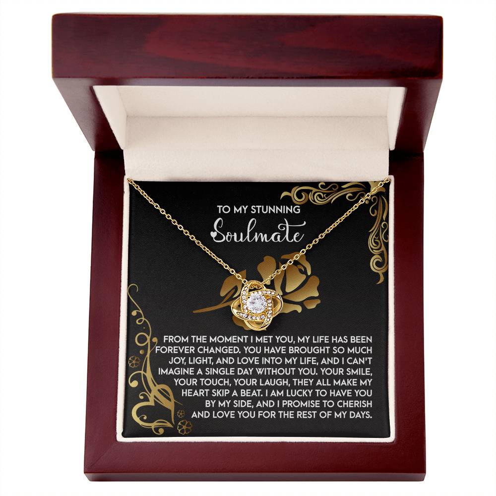 The Soulmate-I Met You 2 Love Knot Necklace shines in a wooden box with a round pendant and ornate floral design. It includes the touching message, "To my stunning soulmate," making it a perfect personalized gift to express your deep connection.