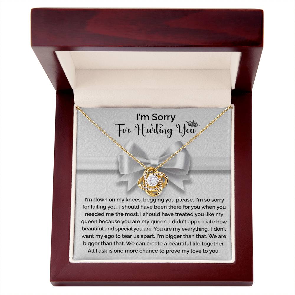 The "Sorry-My Queen - Love Knot Necklace" features a knot-shaped pendant adorned with cubic zirconia crystals and comes in a gift box that includes an apology message, expressing regret and asking for forgiveness and another chance to prove love.