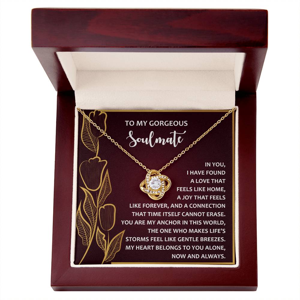 The Soulmate-Gentle Breezes Love Knot Necklace, decorated with sparkling cubic zirconia, comes in a jewelry box. The lid features a message for a "gorgeous soulmate" amidst floral designs and romantic text, symbolizing an unbreakable bond.