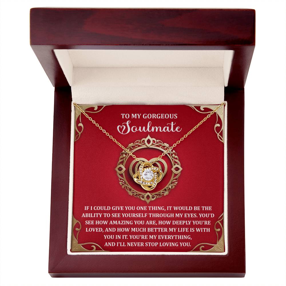 The Soulmate-Through My Eyes - Love Knot Necklace, featuring a cubic zirconia centerpiece, is elegantly presented in a wooden box. Inside is a heartfelt note starting with "To my gorgeous soulmate...," expressing deep love and appreciation, making it the perfect personalized gift.