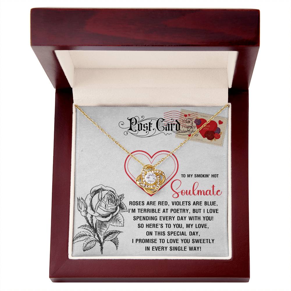The Soulmate-Special Day Love Knot Necklace features a heart pendant with a yellow gold finish and cubic zirconia crystals. It comes in a wooden box with a rose illustration and a poetic message to "Soulmate," making it an enchanting gift.