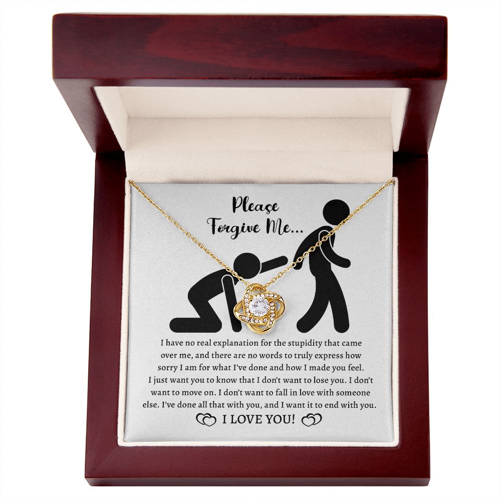 The Sorry-Made You Feel - Love Knot Necklace features a gold, heart-shaped pendant adorned with premium cubic zirconia crystals, and comes elegantly packaged inside a wooden box. A heartfelt written apology note is also included.