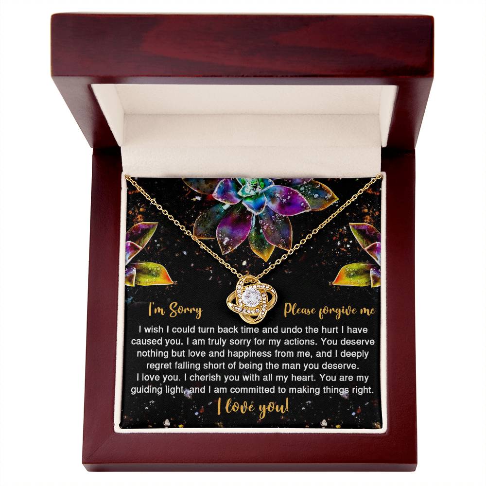 The Sorry-All My Heart - Love Knot Necklace features an interlocking heart pendant on a card with vibrant succulent graphics and the message: "I'm Sorry, Please forgive me. I love you." Adorned with sparkling cubic zirconia crystals, this necklace is available in a choice of white gold or yellow gold finish.