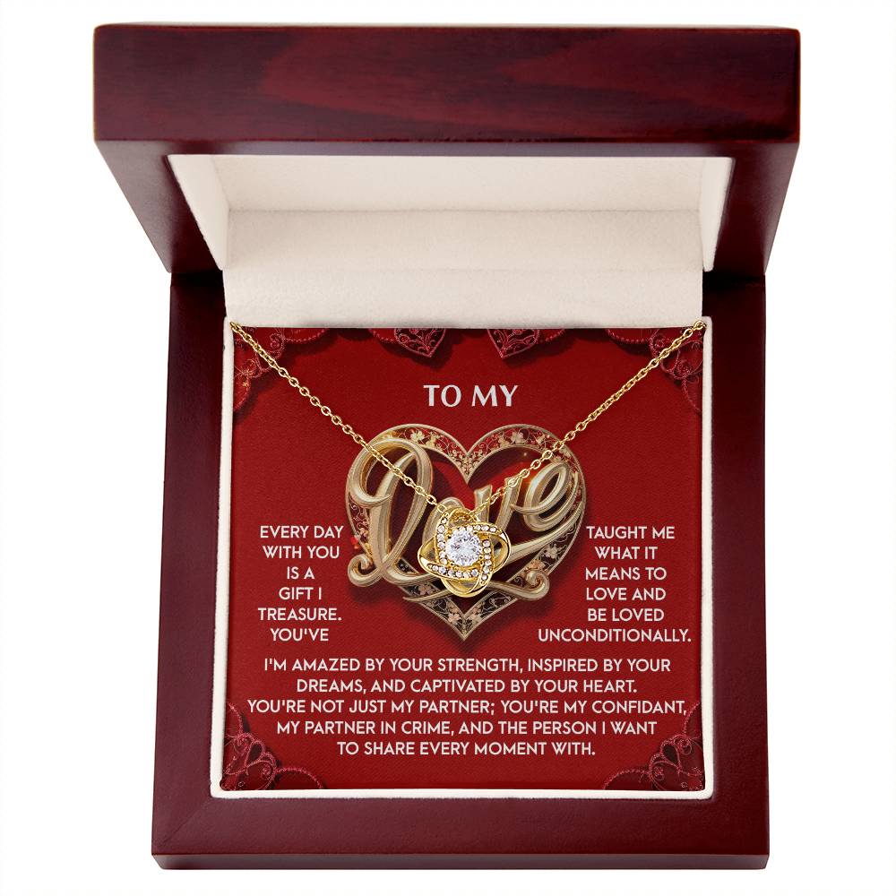 The My Love-Every Moment - Love Knot Necklace is beautifully presented in a box with a heart pendant adorned with cubic zirconia crystals, accompanied by loving text. It's an ideal personalized gift.