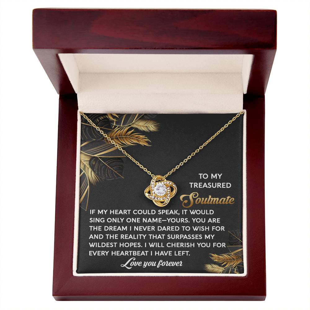 The Soulmate-Wildest Hopes - Love Knot Necklace, featuring a striking cubic zirconia centerpiece, comes elegantly in a wooden box. The heartfelt card reads, "To my treasured soulmate." Choose between white or yellow gold finishes to beautifully symbolize your enduring love.