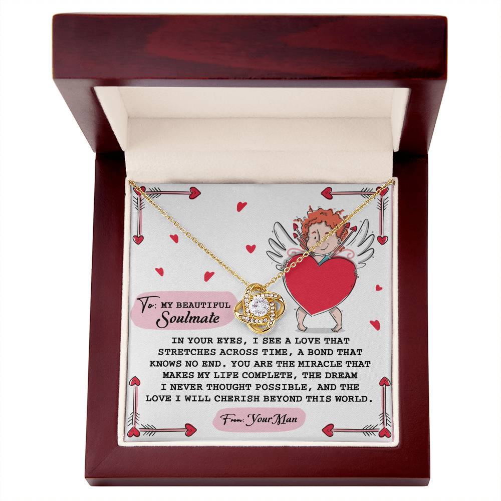 The Soulmate-No End - Love Knot Necklace features interlocking circles with cubic zirconia in white or yellow gold, nestled in a wooden gift box, featuring a romantic cherub design surrounded by heart motifs.