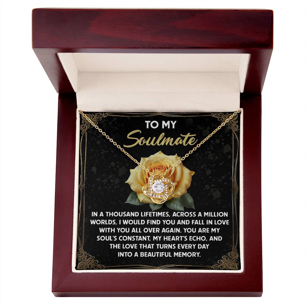 The Soulmate-Beautiful Memory - Love Knot Necklace rests in an open box with a heartfelt message for a soulmate on the lid. Adorned with romantic text and cubic zirconia accents, it's a perfect gift for a loved one.