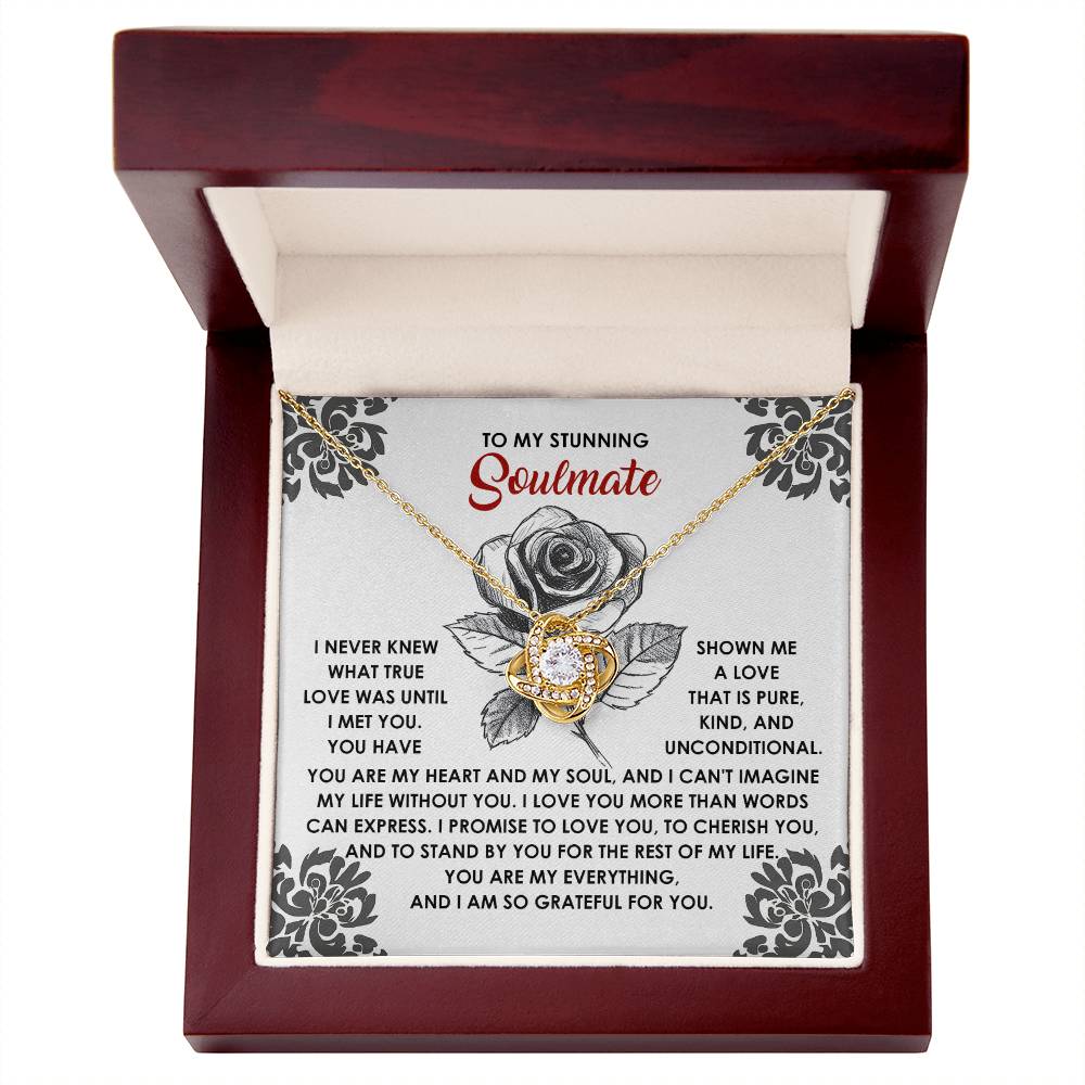 The Soulmate-Cherish You - Love Knot Necklace, presented in a box with a heartfelt message, showcases roses and a decorative pendant embellished with sparkling cubic zirconia, capturing the essence of enduring love.