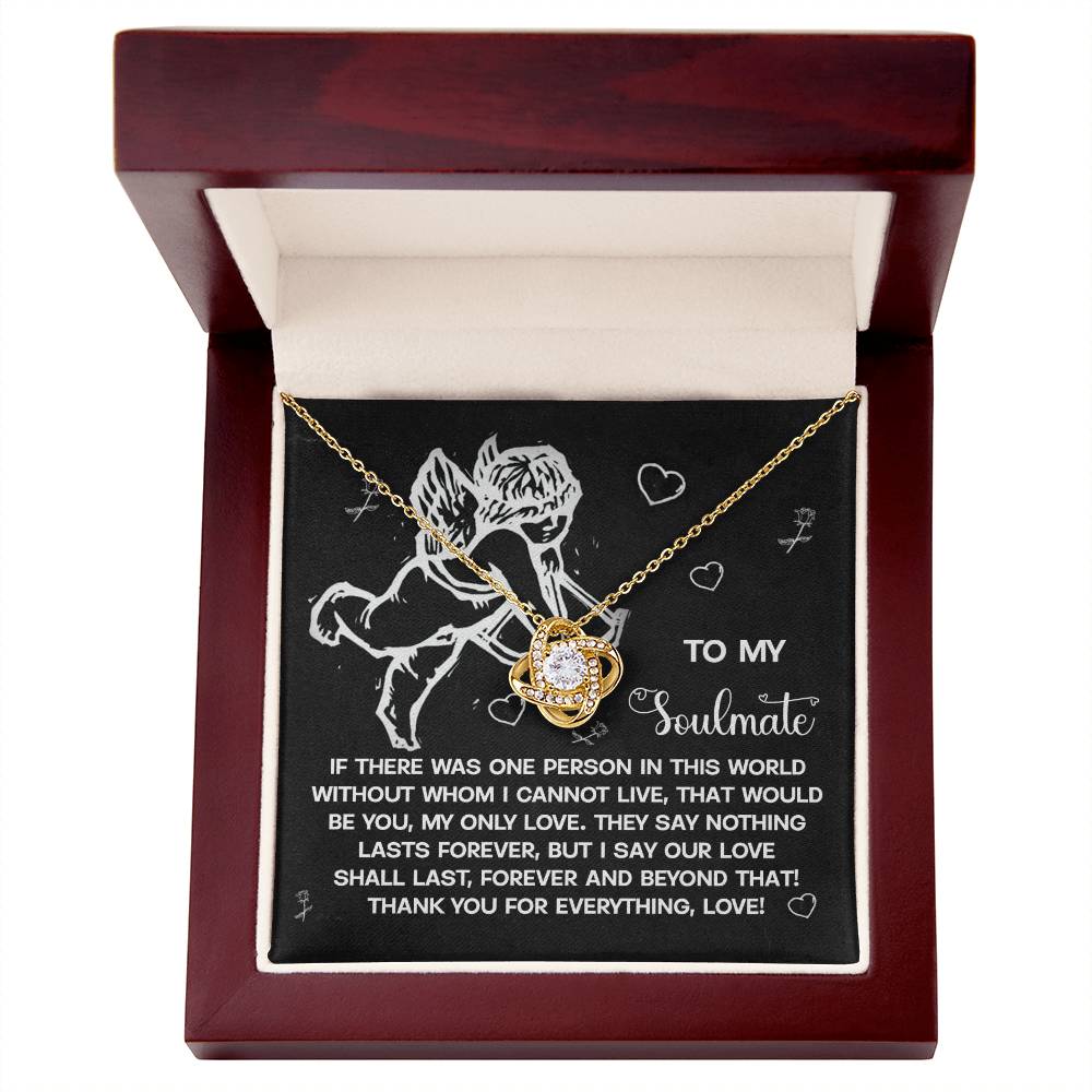 The Soulmate-Lasts Forever Love Knot Necklace features a heart-shaped pendant with cubic zirconia crystals. It comes in a box with an angel graphic on the inner lid, highlighting a heartfelt message about love and soulmates.