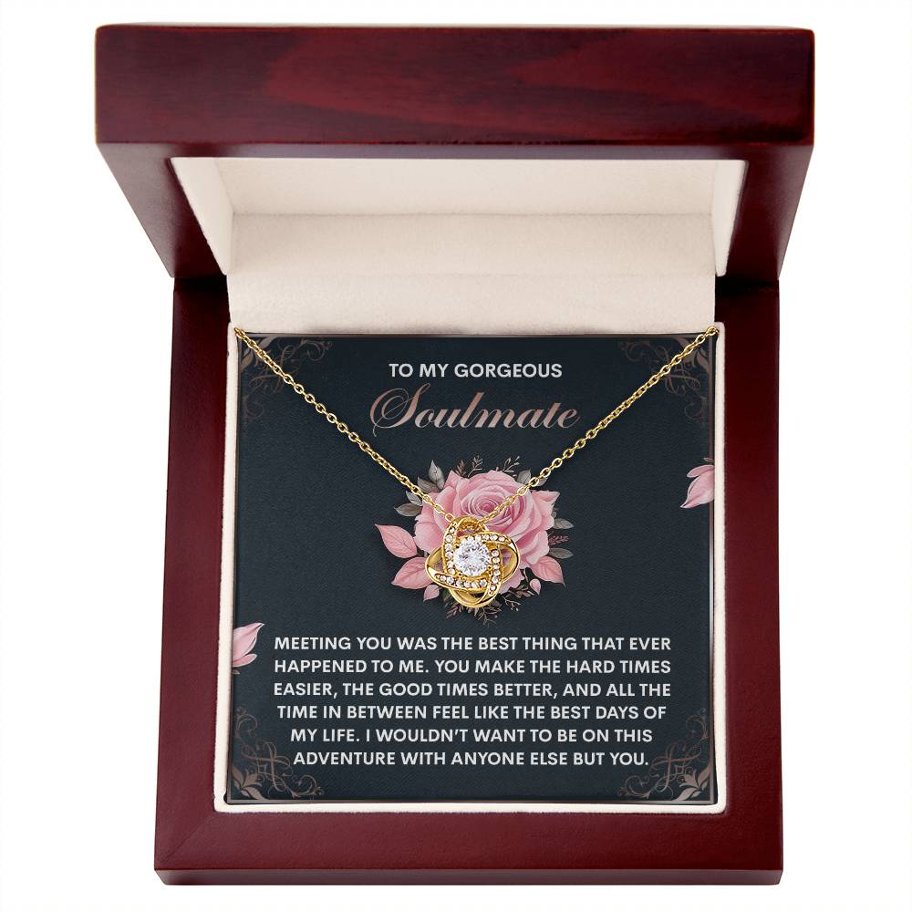 The Soulmate-Best Days Love Knot Necklace, nestled among cubic zirconia crystals, comes in a wooden box with a rose-adorned card and a heartfelt message for your soulmate.