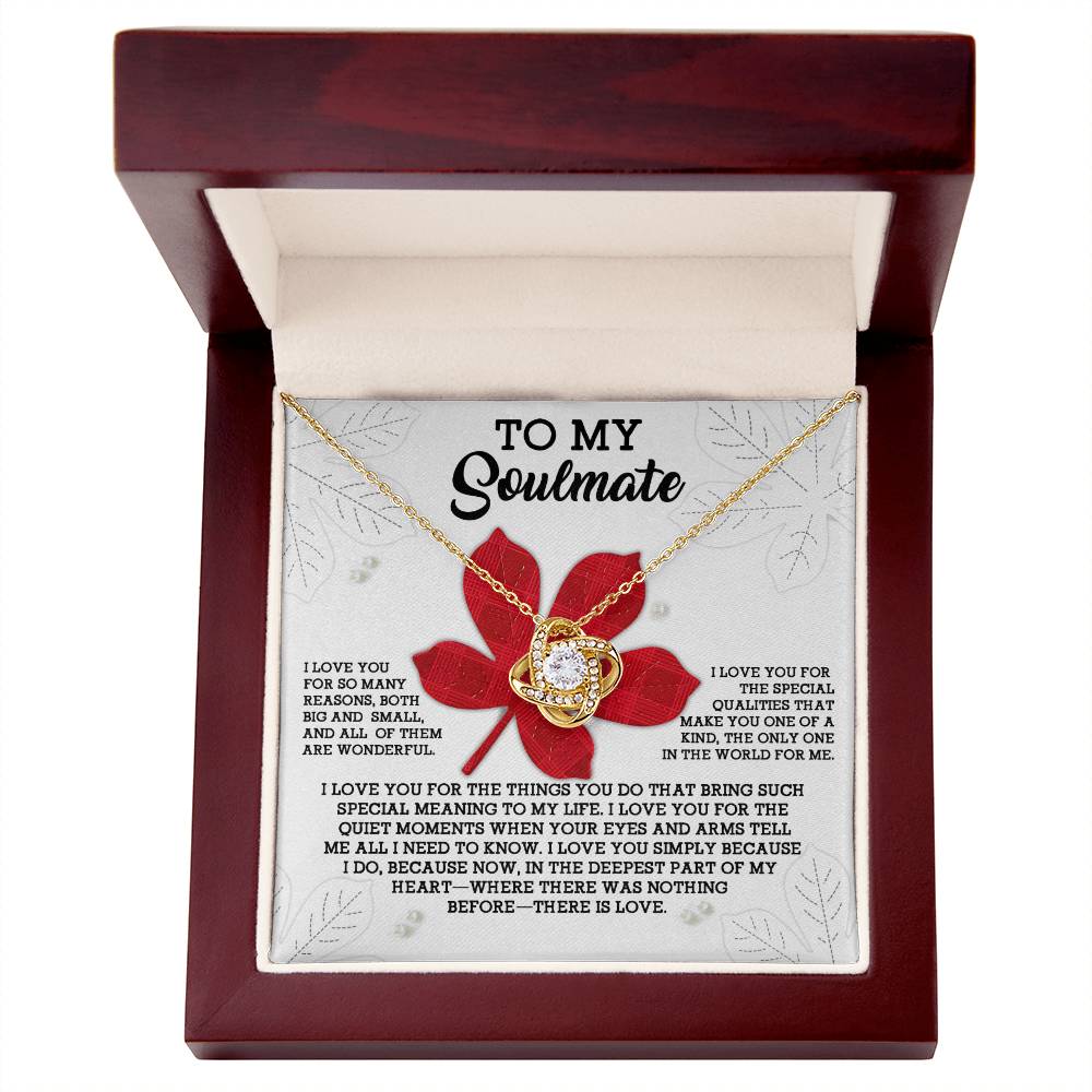 The Soulmate-There Is Love - Love Knot Necklace, featuring a round pendant adorned with sparkling cubic zirconia crystals, is elegantly displayed in a wooden box. The lid of the box bears an inscription that begins with "To My Soulmate" and conveys heartfelt love and appreciation.