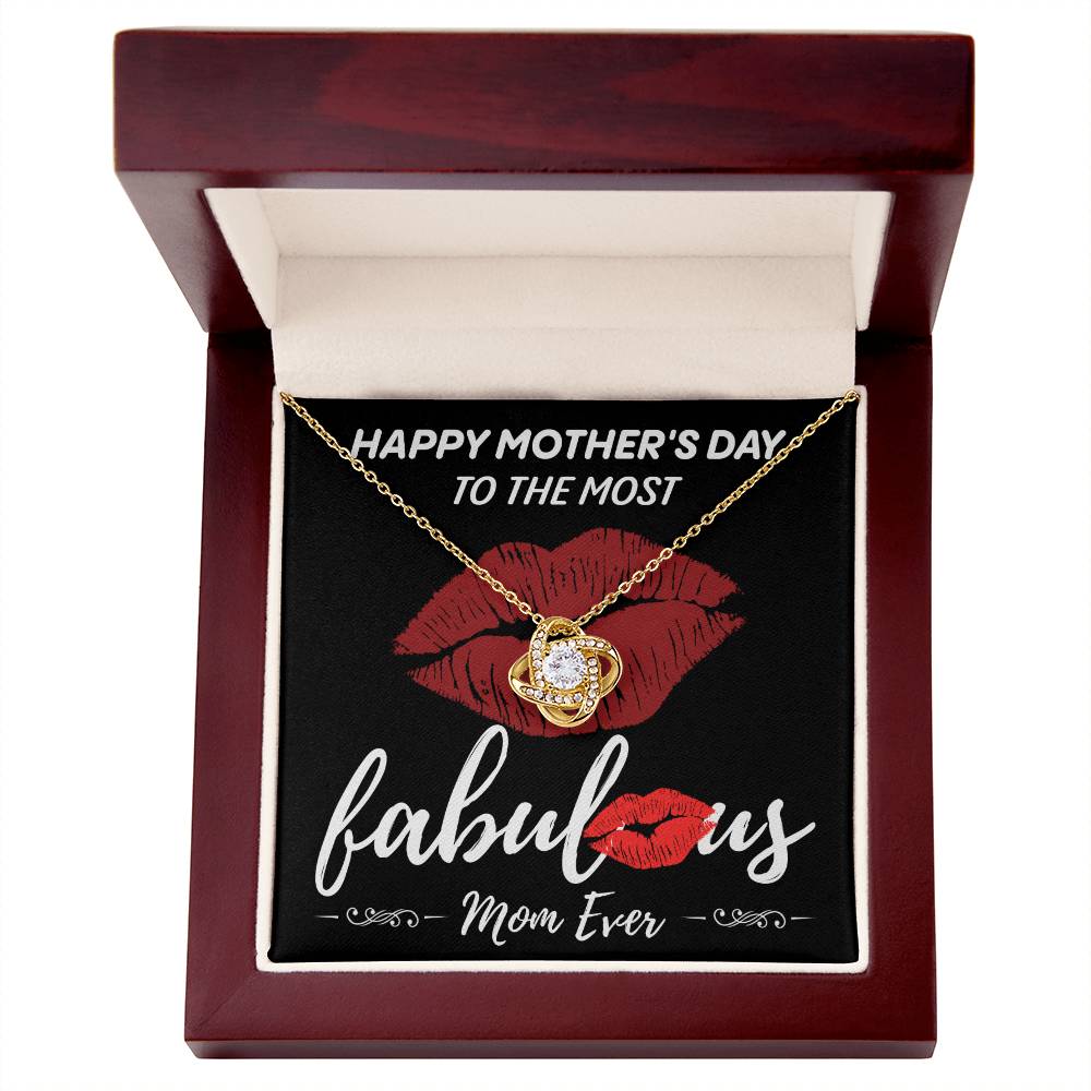 A Love Knot Necklace called "To Mom, The Most Fabulous," adorned with cubic zirconia crystals, rests in an open jewelry box. Inside, it reads, "Happy Mother's Day to the most fabulous mom ever," accompanied by red lipstick marks.