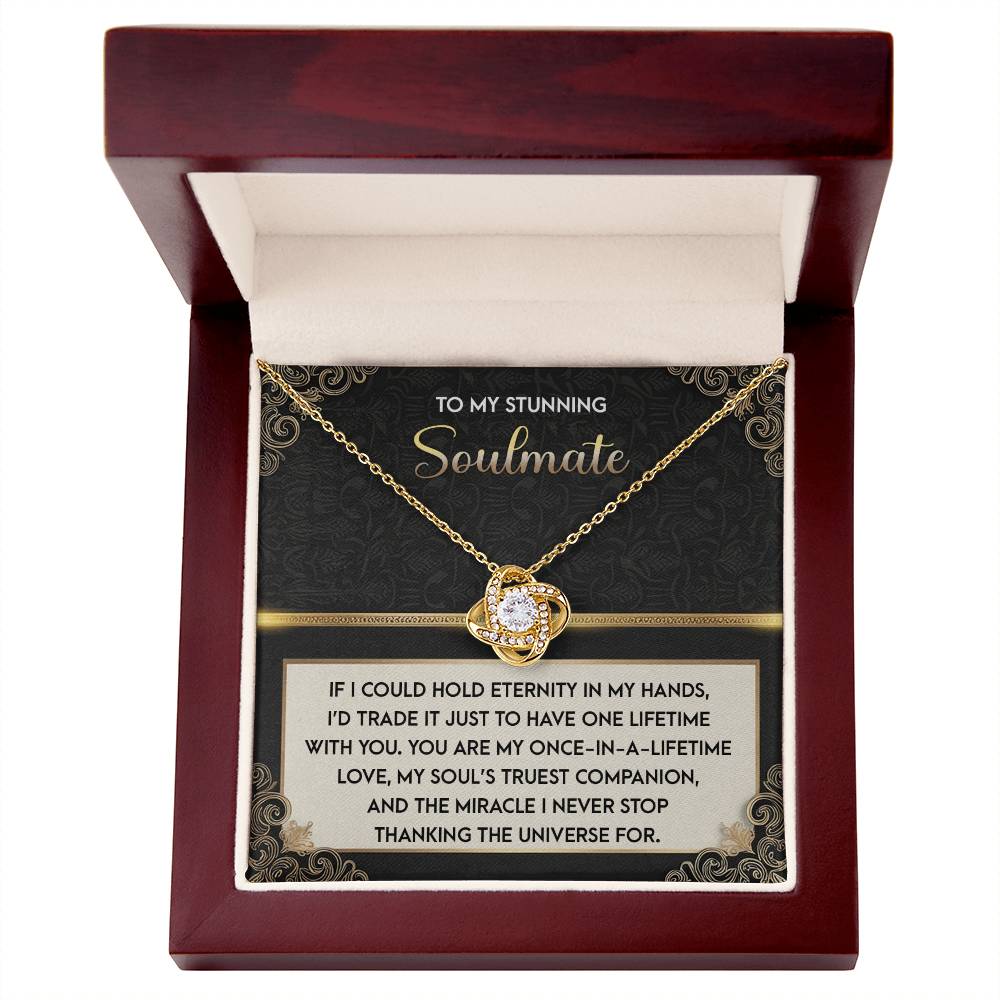The Soulmate-Truest Companion Love Knot Necklace showcases a heart-shaped pendant with sparkling cubic zirconia crystals. It arrives in a wooden box and includes a romantic message card.