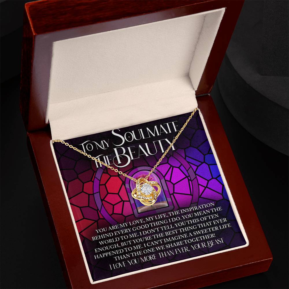 The Soulmate-Sweeter Life - Love Knot Necklace features a heart pendant in a jewelry box with a stained glass backdrop displaying a romantic message. Decorated with shimmering cubic zirconia crystals, it's the perfect personalized gift.