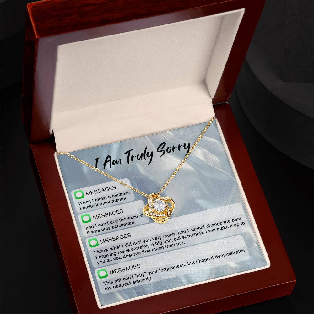 The "Sorry, Make A Mistake - Love Knot Necklace" adorned with cubic zirconia crystals, placed over a background card that reads "I Am Truly Sorry" and includes a series of apology text messages, is the perfect personalized gift for heartfelt apologies.