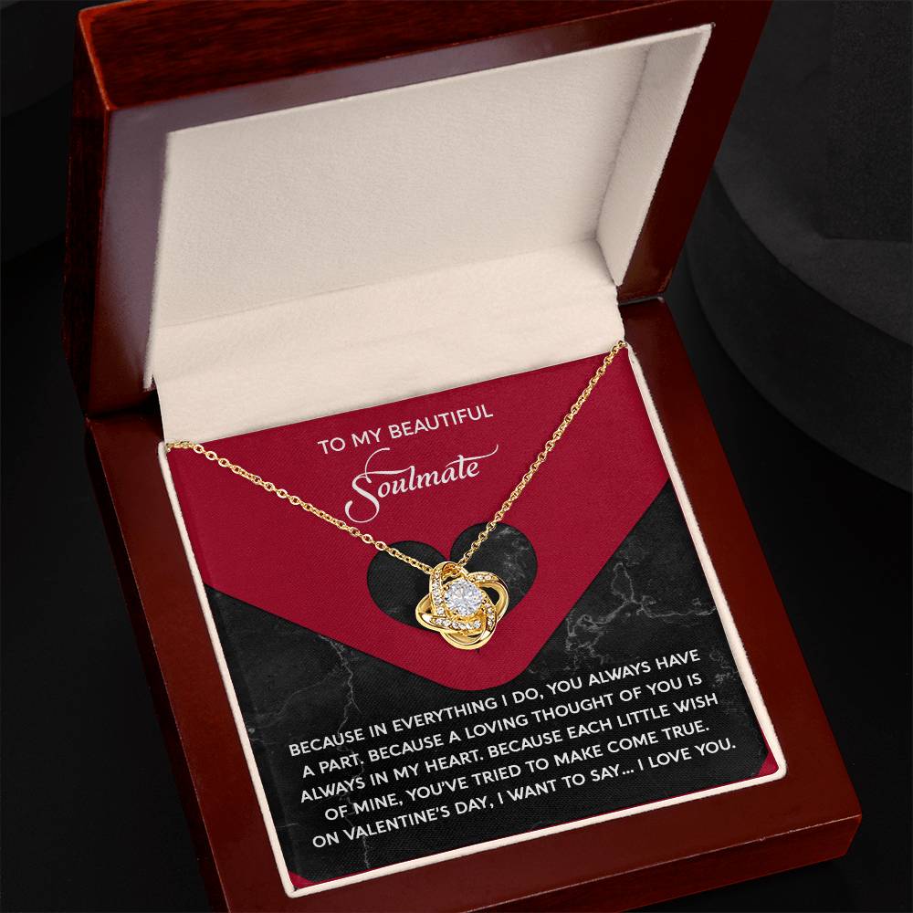 The Soulmate-Loving Thought - Love Knot Necklace, adorned with cubic zirconia crystals, rests elegantly in an open box. The lid reads "To My Beautiful Soulmate" and includes a heartfelt message, making it an ideal personalized gift.
