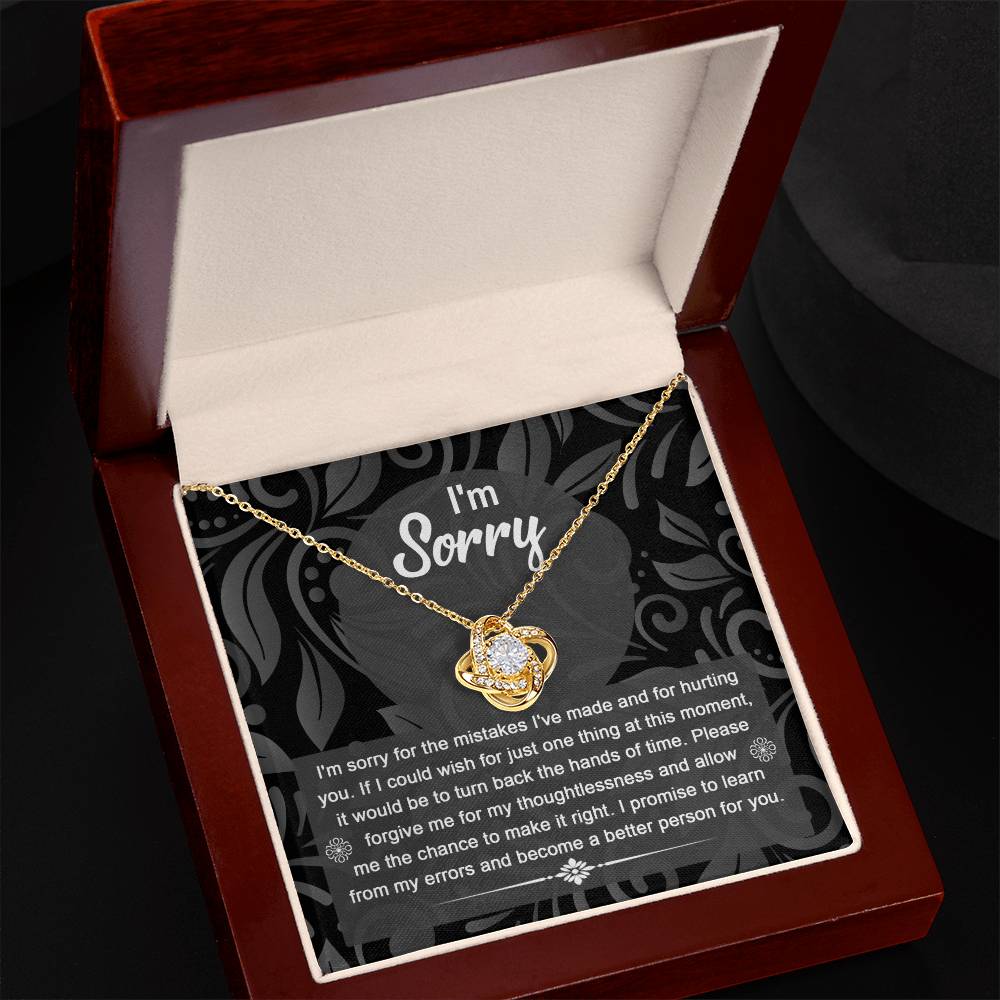 Introducing the "Sorry-Just One Thing - Love Knot Necklace": a beautiful gold necklace featuring a heart-shaped pendant encrusted with cubic zirconia crystals. It comes elegantly presented in a luxurious box, with the lid inscribed "I’m Sorry" and an apology message written underneath. This heartfelt gift is perfect for mending hearts and expressing sincere apologies.