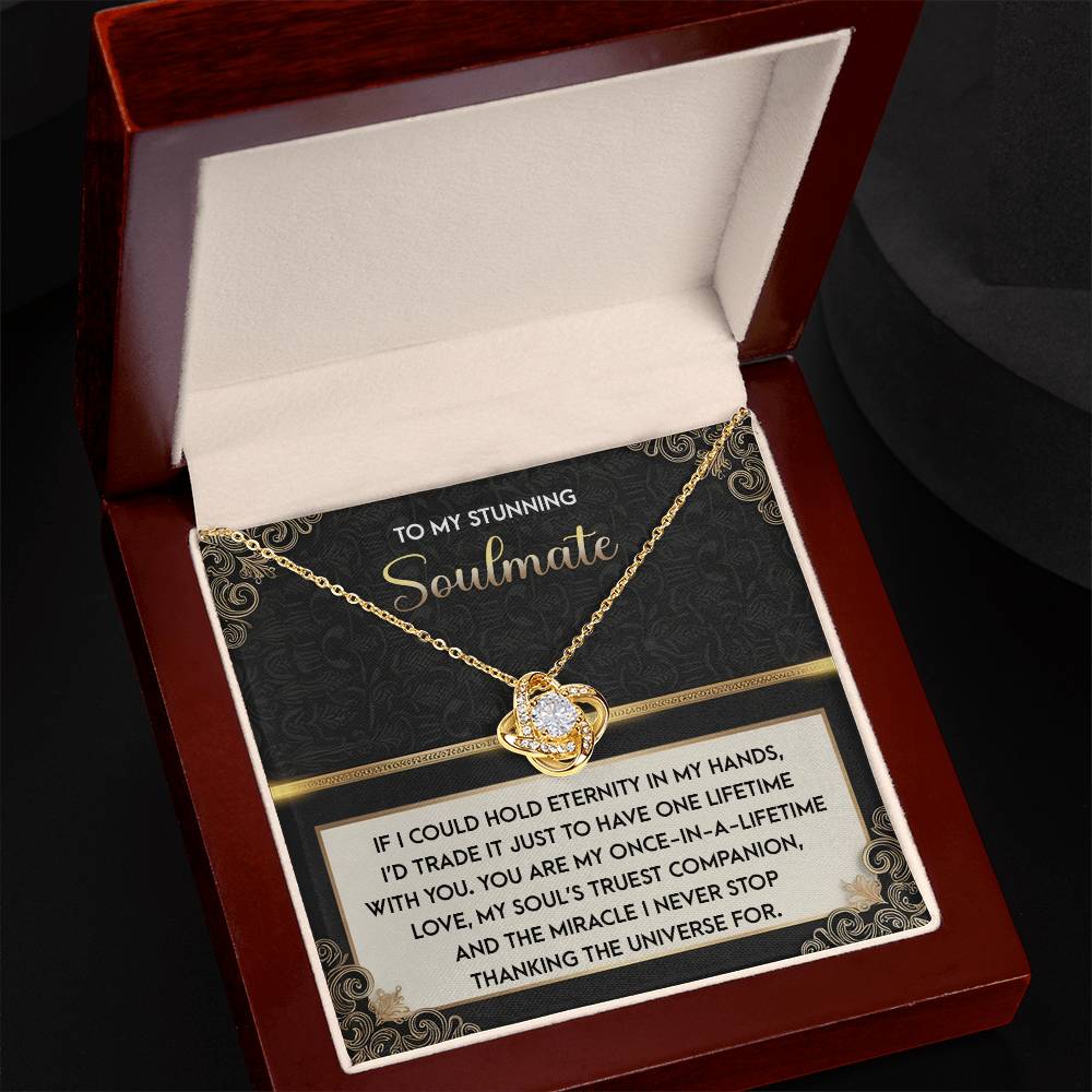 The Soulmate-Truest Companion Love Knot Necklace comes in a gift box, adorned with cubic zirconia crystals and gold finish, featuring a sentimental message about soulmates.